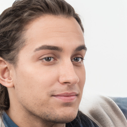 Joyful white young-adult male with medium  brown hair and grey eyes