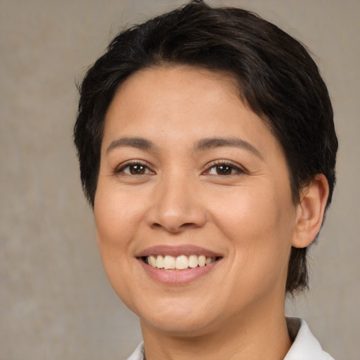 Joyful latino young-adult female with medium  brown hair and brown eyes