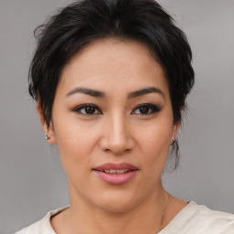 Joyful asian young-adult female with short  brown hair and brown eyes