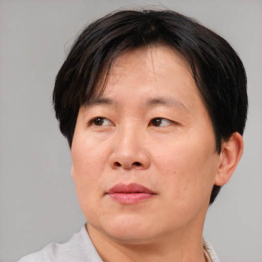 Joyful asian adult male with short  brown hair and brown eyes