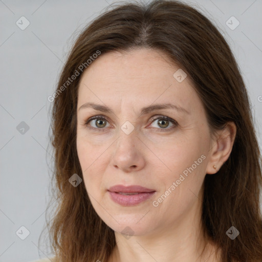 Joyful white adult female with long  brown hair and brown eyes