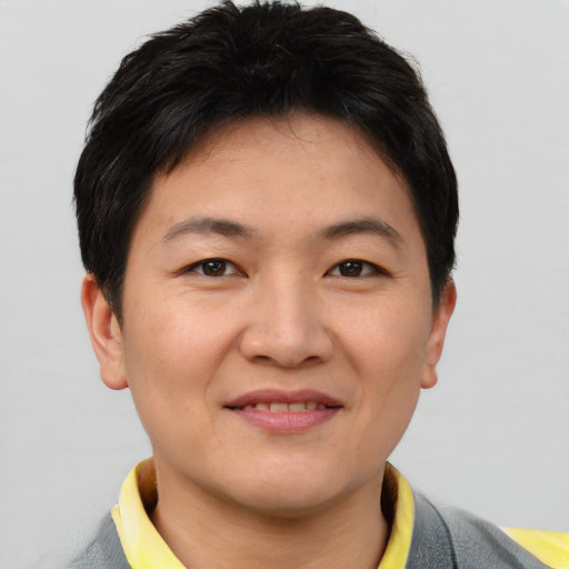 Joyful asian young-adult male with short  brown hair and brown eyes