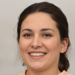 Joyful white adult female with medium  brown hair and brown eyes