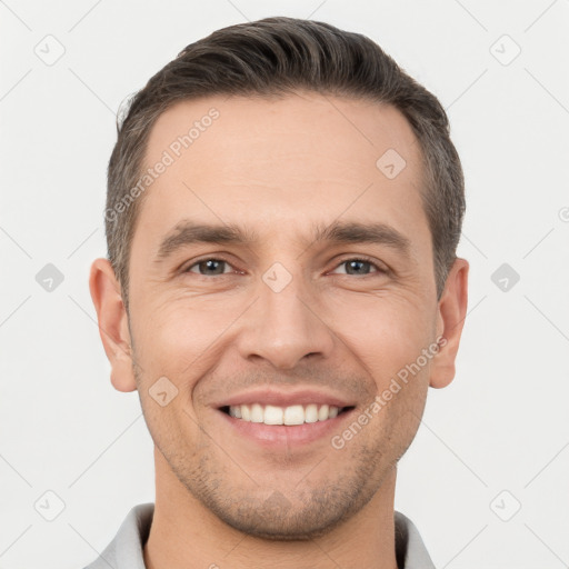 Joyful white young-adult male with short  brown hair and brown eyes