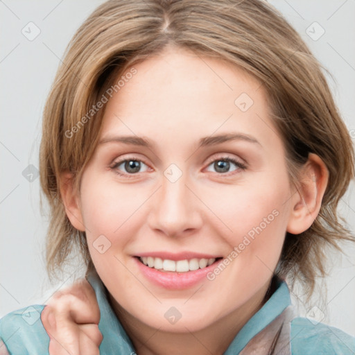 Joyful white young-adult female with medium  brown hair and blue eyes