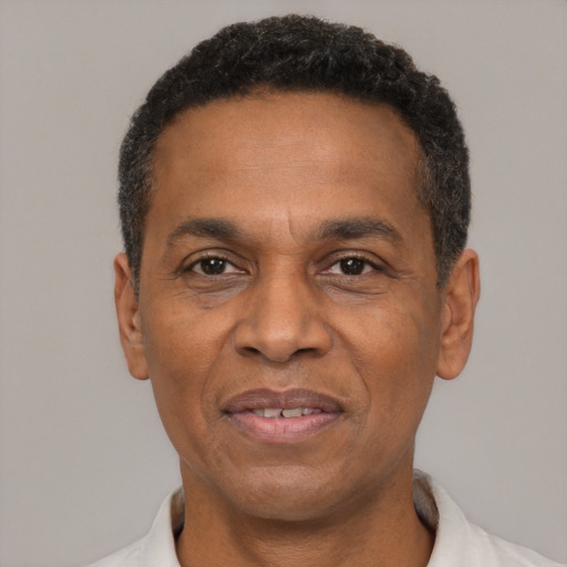 Joyful latino adult male with short  black hair and brown eyes