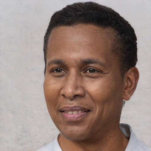 Joyful latino adult male with short  brown hair and brown eyes