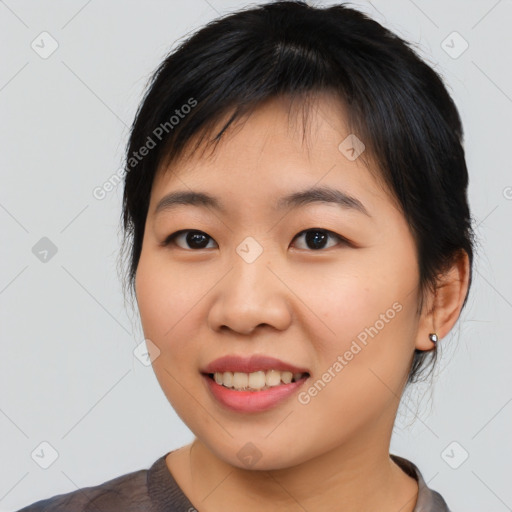 Joyful asian young-adult female with medium  black hair and brown eyes