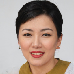 Joyful asian young-adult female with short  black hair and brown eyes