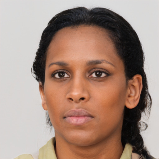 Neutral black young-adult female with medium  brown hair and brown eyes