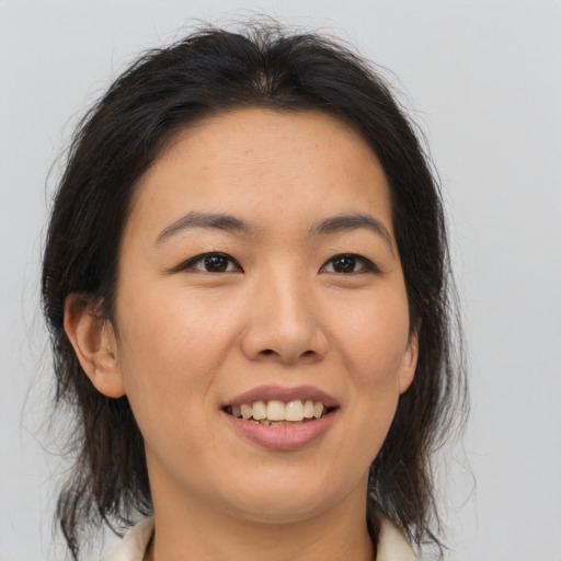 Joyful asian young-adult female with medium  brown hair and brown eyes