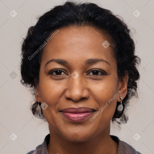 Joyful black adult female with medium  brown hair and brown eyes