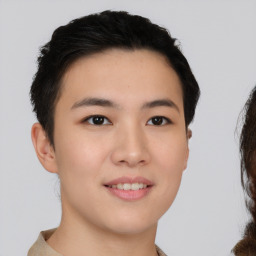 Joyful asian young-adult female with short  brown hair and brown eyes