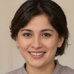 Joyful white young-adult female with medium  brown hair and brown eyes