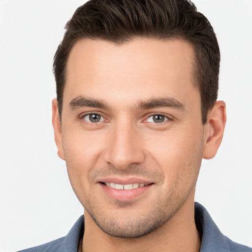 Joyful white young-adult male with short  brown hair and brown eyes