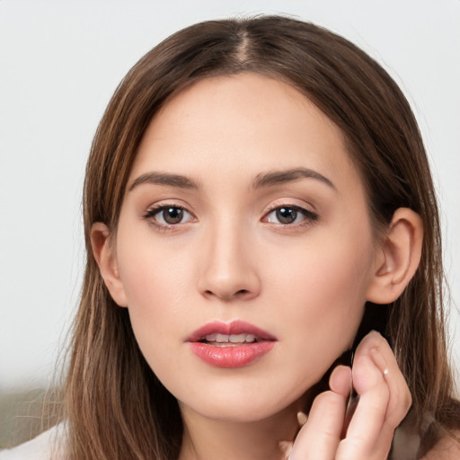 Neutral white young-adult female with long  brown hair and brown eyes