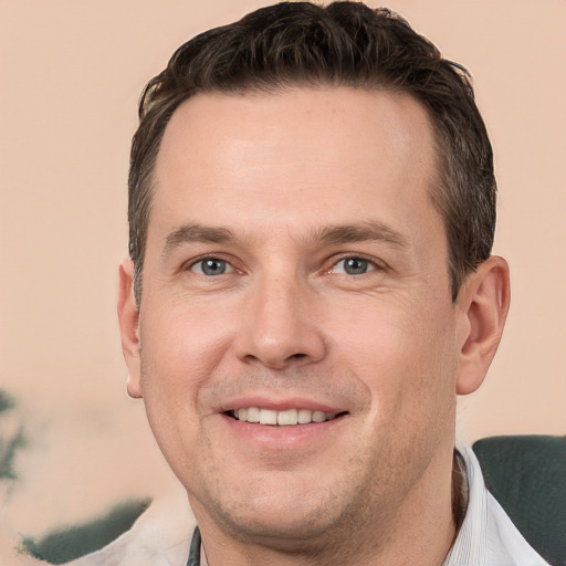 Joyful white adult male with short  brown hair and brown eyes