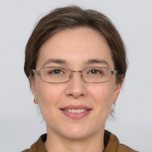 Joyful white adult female with medium  brown hair and grey eyes