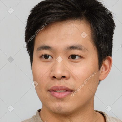 Joyful asian young-adult male with short  brown hair and brown eyes