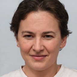 Joyful white adult female with short  brown hair and brown eyes