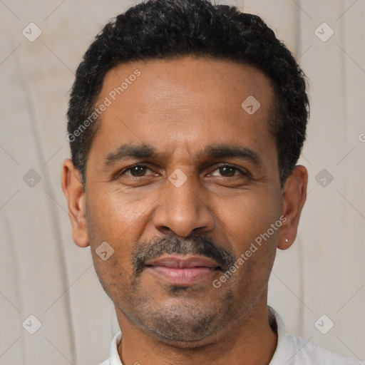 Joyful latino adult male with short  black hair and brown eyes