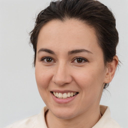 Joyful white young-adult female with medium  brown hair and brown eyes