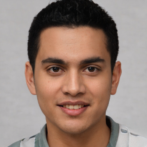 Joyful white young-adult male with short  black hair and brown eyes