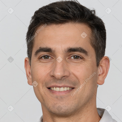 Joyful white adult male with short  brown hair and brown eyes