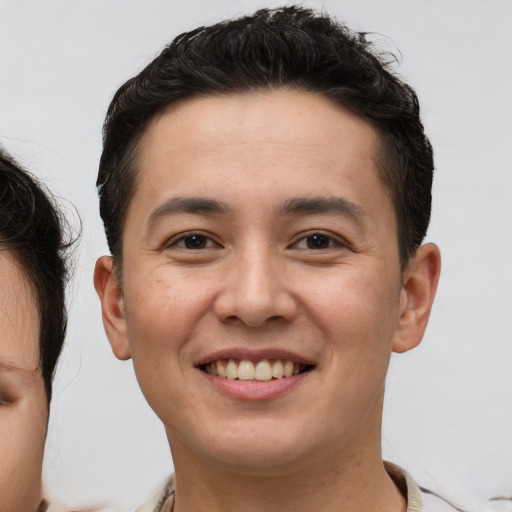 Joyful white young-adult male with short  brown hair and brown eyes