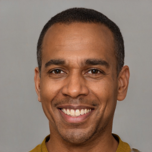 Joyful latino adult male with short  black hair and brown eyes