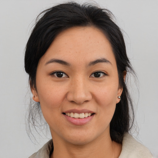 Joyful asian young-adult female with medium  brown hair and brown eyes