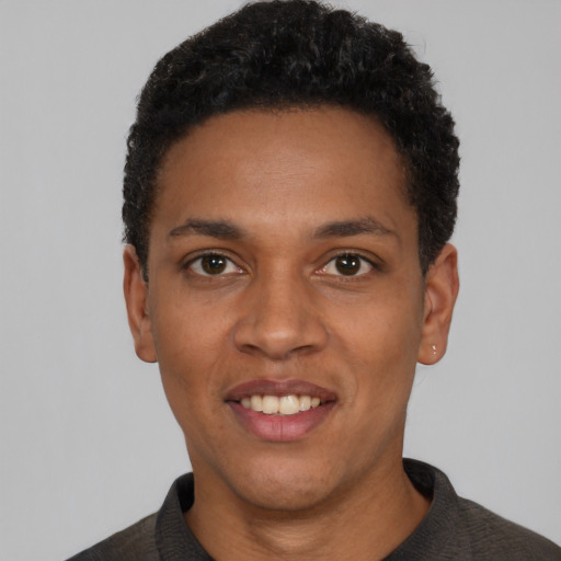 Joyful black young-adult male with short  black hair and brown eyes