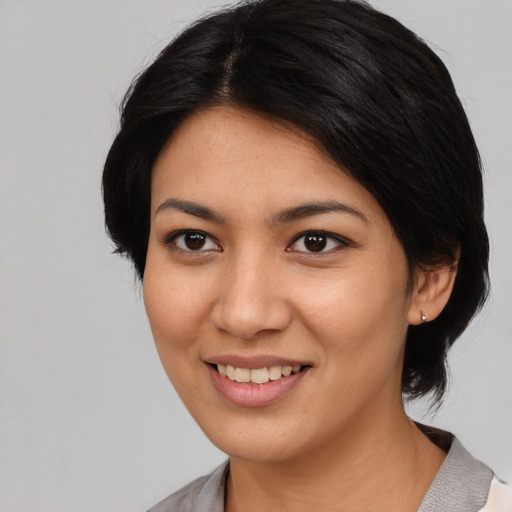 Joyful asian young-adult female with medium  black hair and brown eyes