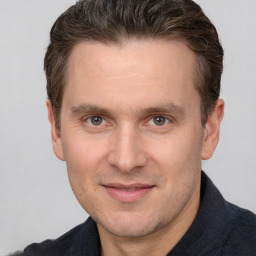 Joyful white adult male with short  brown hair and brown eyes