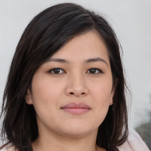 Joyful asian young-adult female with long  brown hair and brown eyes
