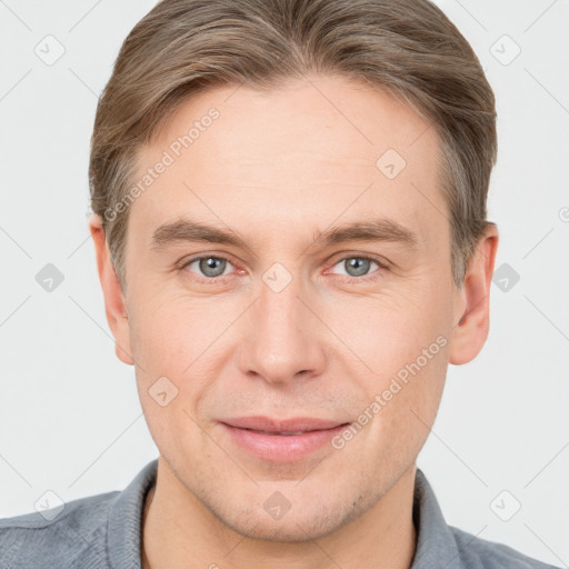 Joyful white adult male with short  brown hair and grey eyes