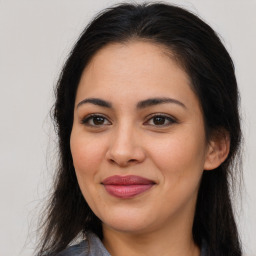 Joyful latino young-adult female with long  brown hair and brown eyes