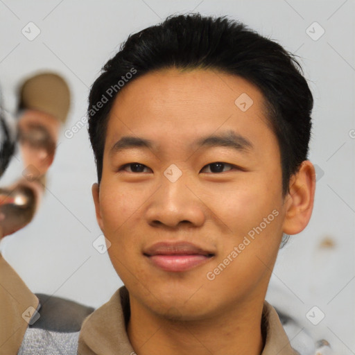 Joyful asian young-adult male with short  black hair and brown eyes