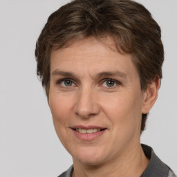 Joyful white adult female with short  brown hair and brown eyes