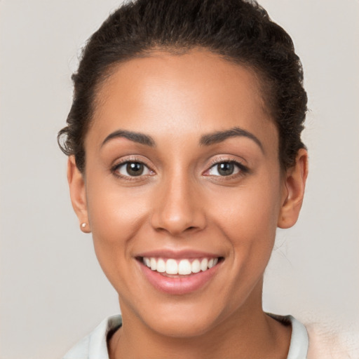 Joyful white young-adult female with short  brown hair and brown eyes