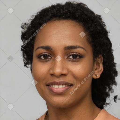 Joyful black young-adult female with long  black hair and brown eyes