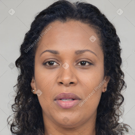 Joyful black adult female with long  brown hair and brown eyes