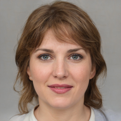 Joyful white young-adult female with medium  brown hair and blue eyes