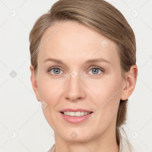 Joyful white young-adult female with medium  brown hair and blue eyes