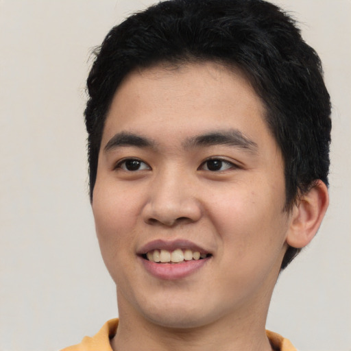 Joyful asian young-adult male with short  black hair and brown eyes