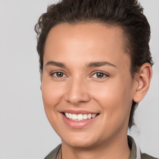 Joyful white young-adult female with short  brown hair and brown eyes