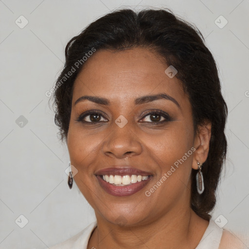 Joyful black adult female with medium  brown hair and brown eyes