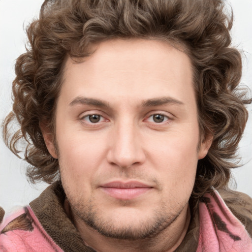 Joyful white young-adult male with short  brown hair and blue eyes