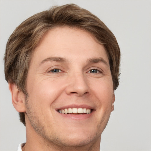 Joyful white adult male with short  brown hair and grey eyes