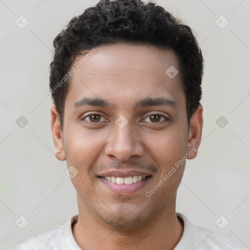 Joyful latino young-adult male with short  brown hair and brown eyes